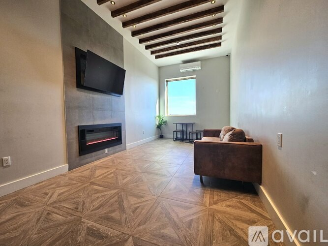 A living room with a fireplace and a television mounted on the wall.