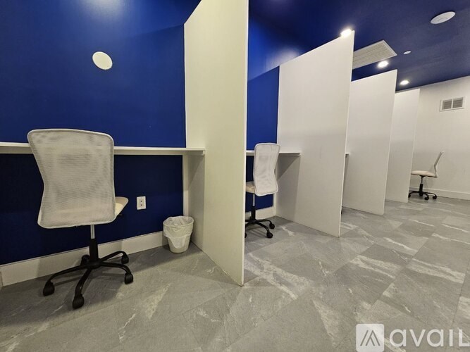 A room with blue walls and a white chair with wheels.