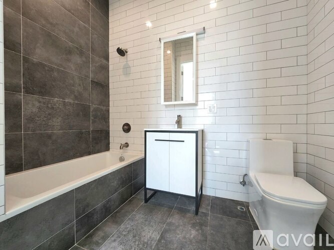 A bathroom with a white toilet and a white cabinet.