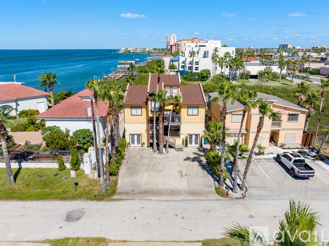 A view of a residential area with houses and a parking lot.