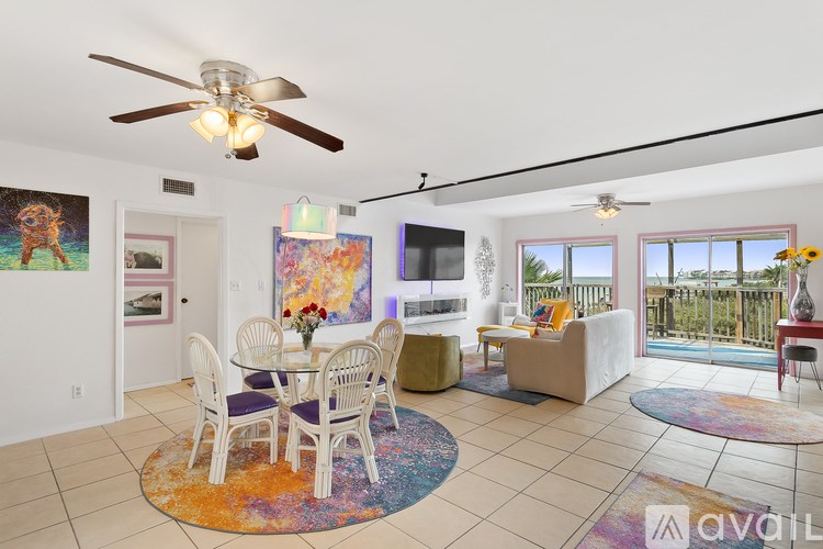 A living room with a dining table and chairs.