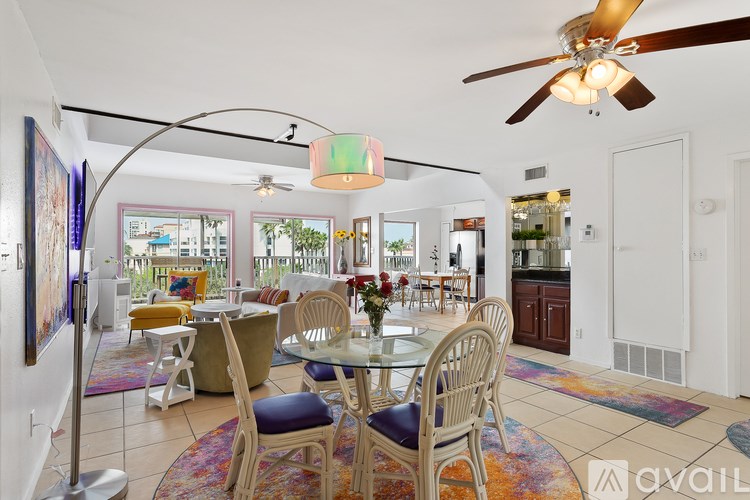 A dining room with a white table and chairs.
