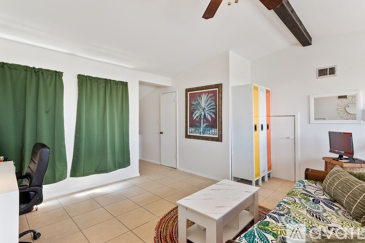 A room with a bed, a desk, and a chair.