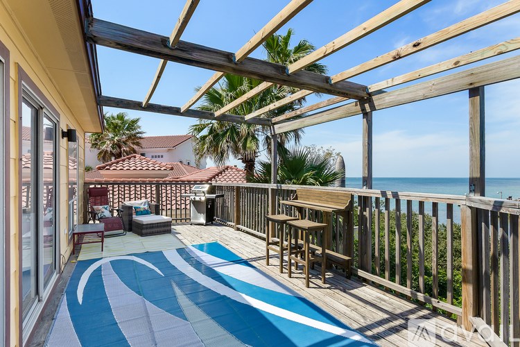 A wooden deck with a blue and white patterned floor.