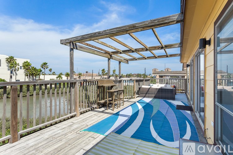 A wooden deck with a blue and white patterned mat.