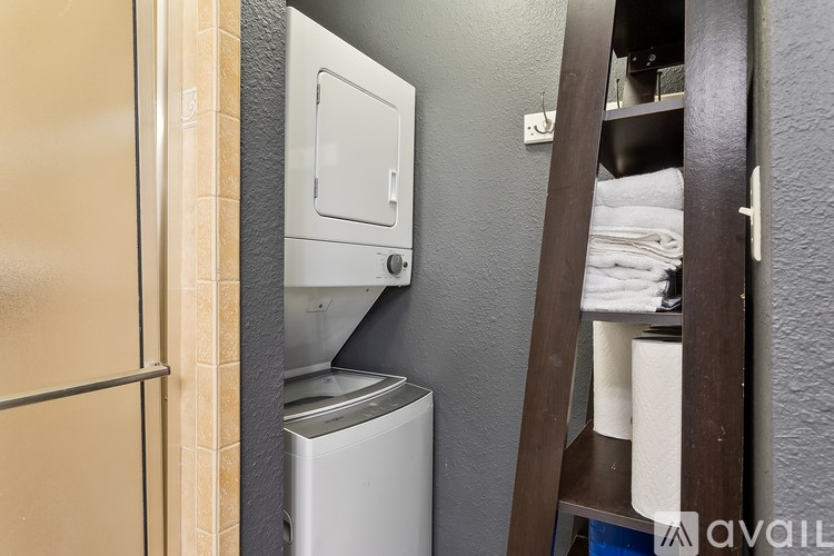 A bathroom with a toilet paper roll on a shelf.