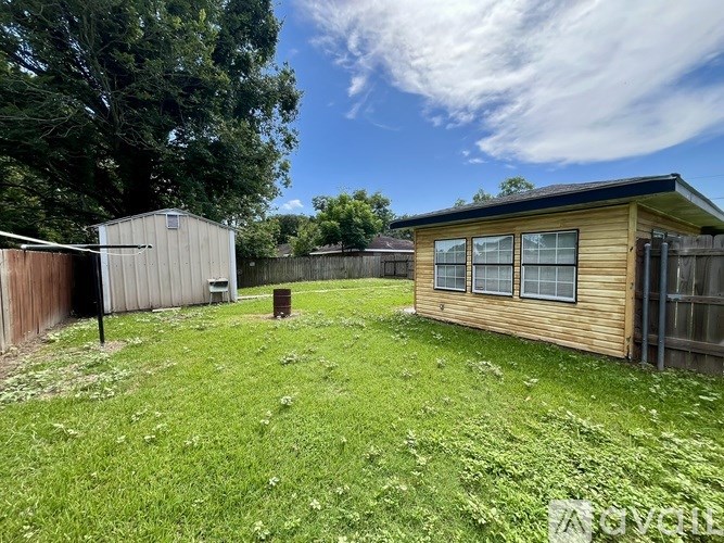 A backyard with a wooden shed and a wooden fence.