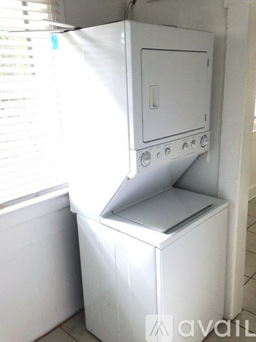 A white oven with a door open is in a room.