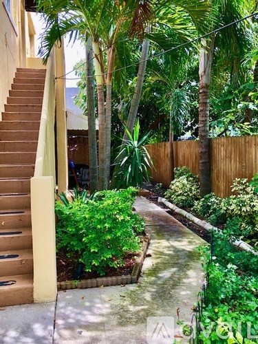 A staircase with a yellow railing leads up to a house.