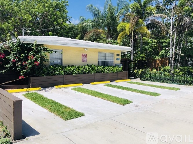 A yellow house with a white roof and a red sign on the front.