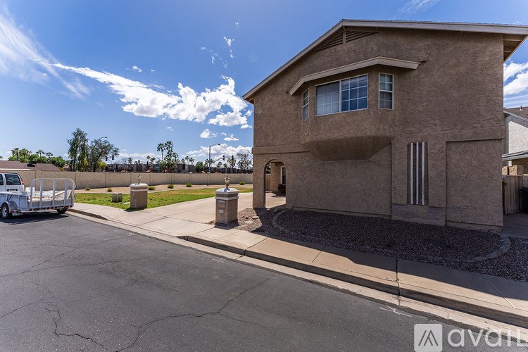 A house with a driveway and a car parked in front.