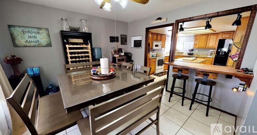 A kitchen with a dining table and chairs is shown in the image.