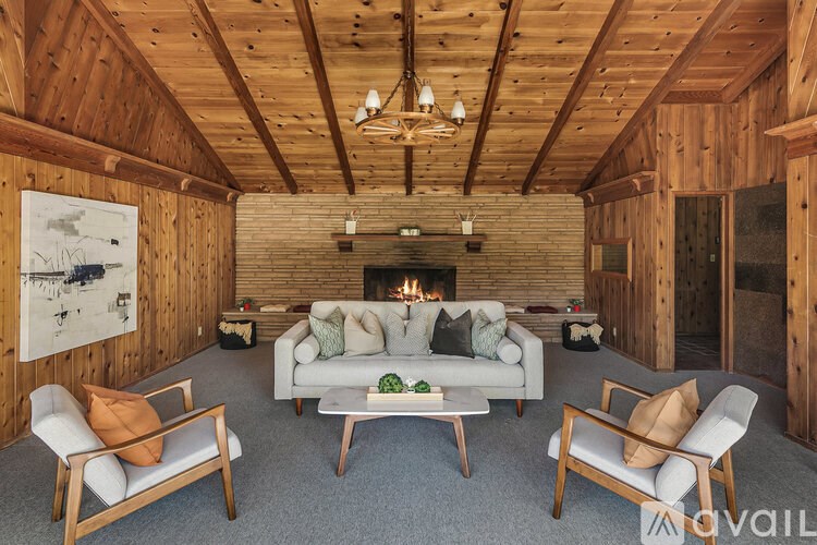 A cozy living room with a fireplace and comfortable seating.