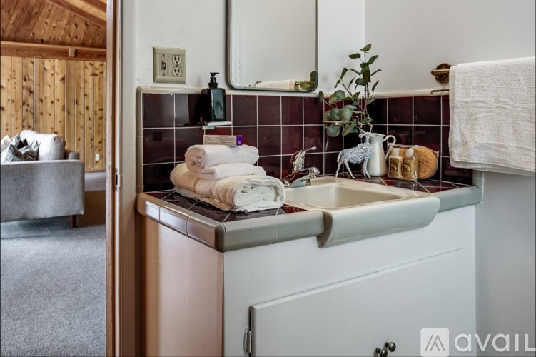 A bathroom with a copper sink and a white cabinet.