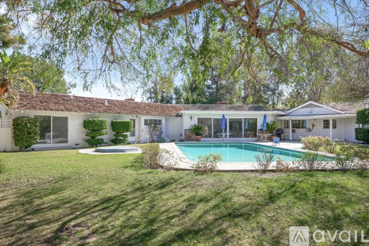 A house with a pool in the backyard.