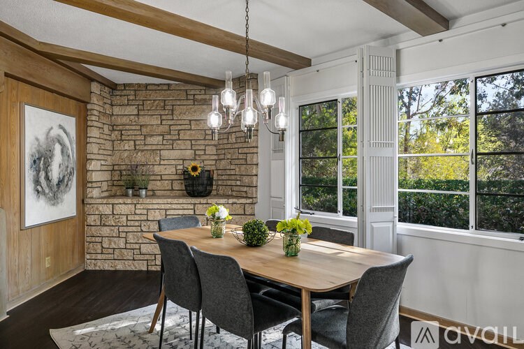 A dining room with a wooden table and chairs.