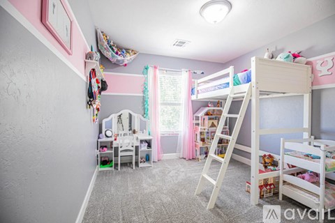 A child's bedroom with a bunk bed and a desk.