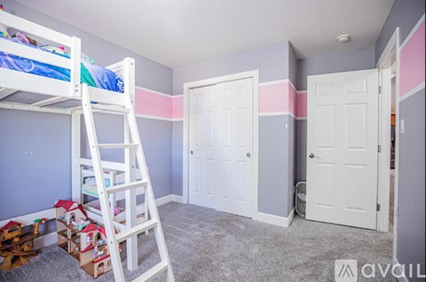 A room with a bunk bed and a ladder.