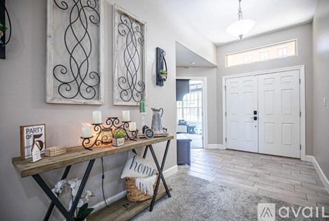 A room with a wooden table and candles on it.