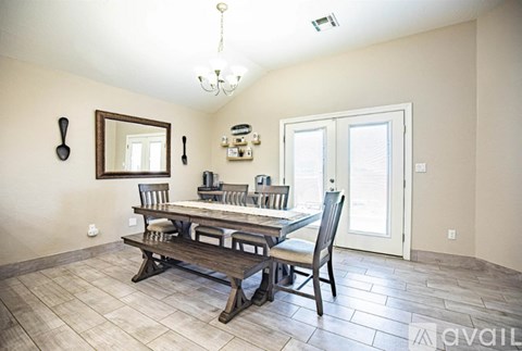 A dining room with a wooden table and chairs.