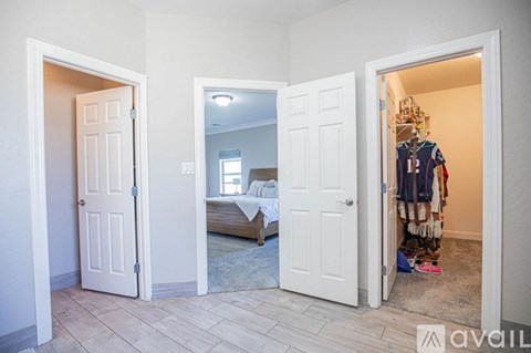 A bedroom with a bed, a closet, and a mirror.