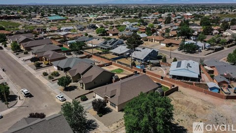 A bird's eye view of a residential area with houses and streets.