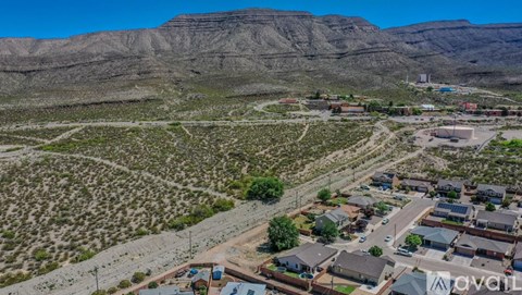 A small town with houses and a mountain in the background.