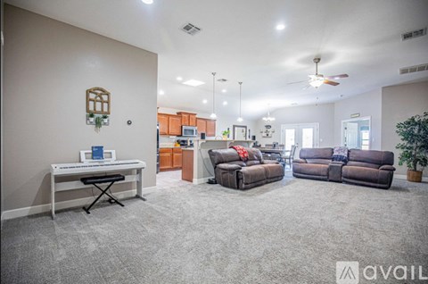 A living room with a piano and a couch.