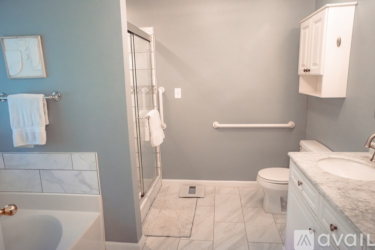 A bathroom with a toilet, sink, and shower.