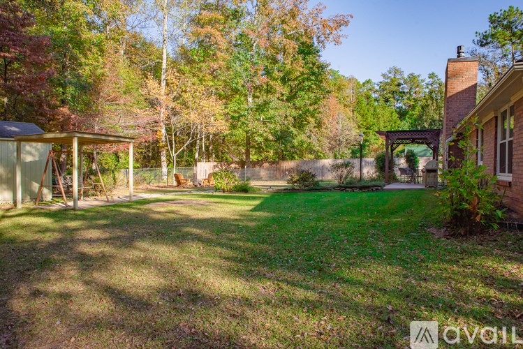 A backyard with a shed and a fence.