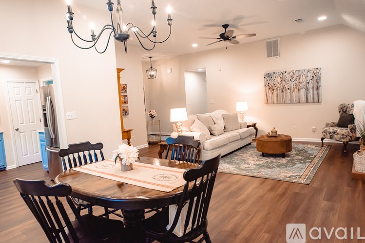 A dining room with a wooden table and chairs.