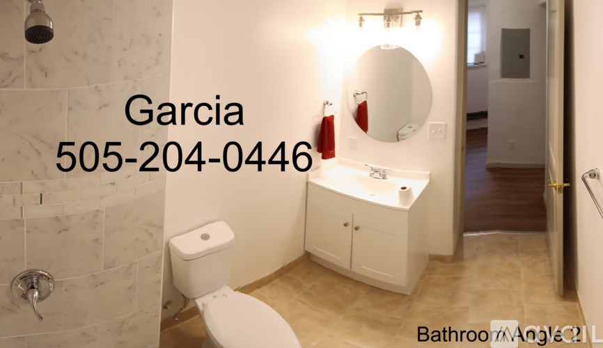 A bathroom with a white toilet and a white sink.