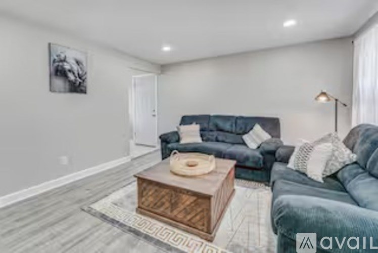 A living room with a grey couch and a wooden coffee table.