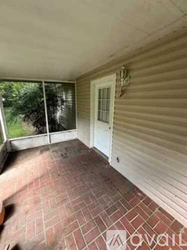A room with a tiled floor and a sliding glass door.