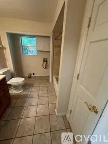 A bathroom with a toilet and a door.