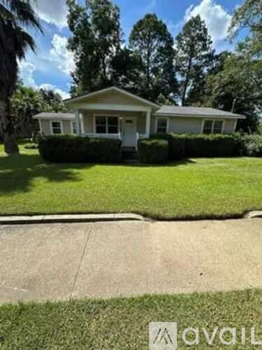 A house with a white front yard and a white fence.