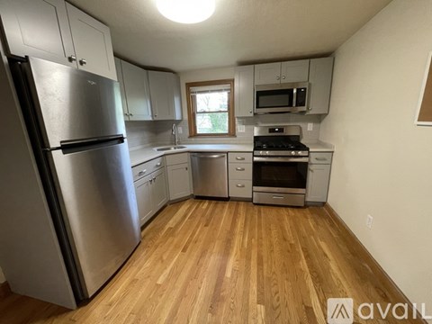 A kitchen with wooden floors and stainless steel appliances.