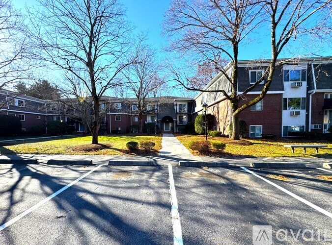 A street view of a residential area with houses and trees.