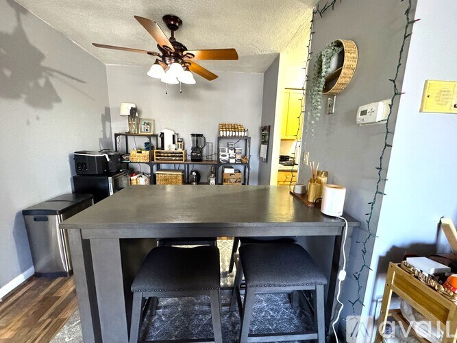 A dining room with a table and chairs.