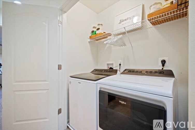 A white oven with a black stove top sits under a shelf with a sign that says "Lavender".