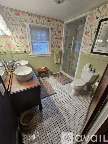 A bathroom with a sink, toilet, and shower.