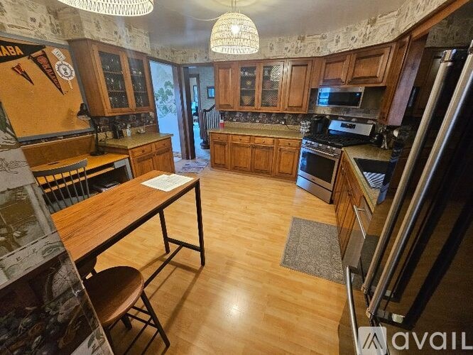 A kitchen with wooden floors and furniture.