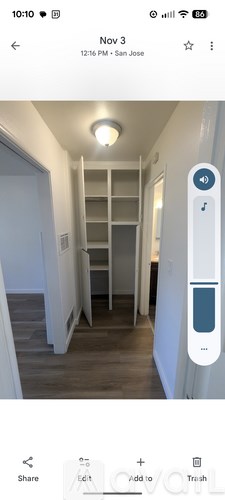 A hallway with a thermostat on the wall.