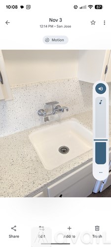 A digital thermometer is displayed on a smartphone screen, showing a temperature reading.