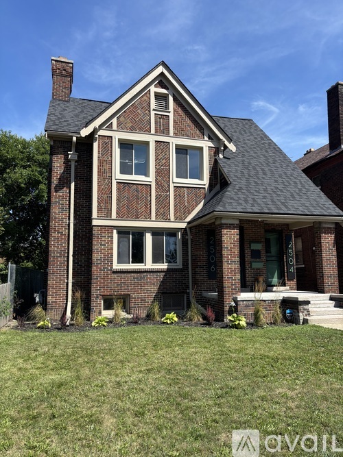 A brick house with a large front porch.