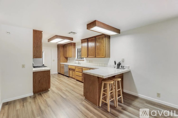 A kitchen with wooden cabinets and a white countertop.