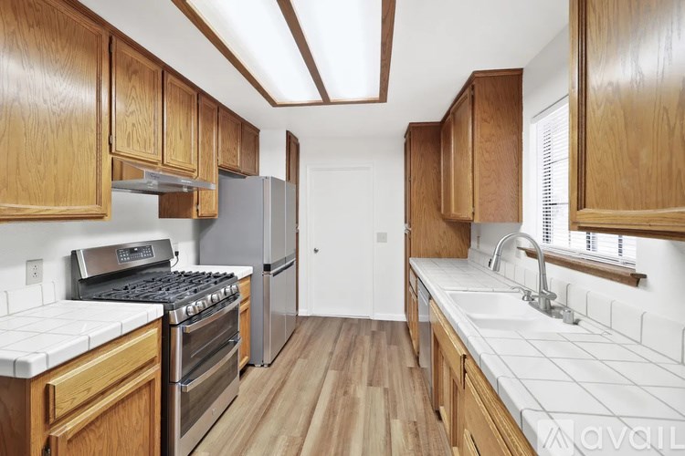 A kitchen with wooden cabinets and stainless steel appliances.