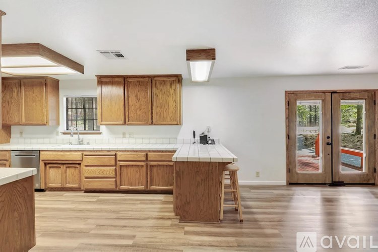 A kitchen with wooden cabinets and a white countertop.
