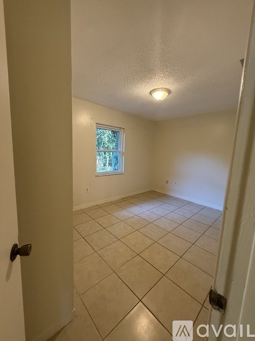A room with beige walls and a tiled floor.