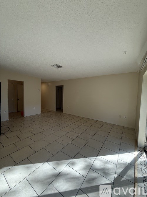 A room with tiled flooring and a ceiling fan.
